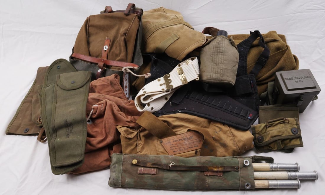 LOT OF 18 WWII US MILITARY & CANVAS FIELD GEAR: Lot of eighteen (18) various WWII US military gear including a white canvas web belt, five (5) canvas carrying cases, a canvas duffle bag, a Boy Scouts of America National Council day hike bag(named,