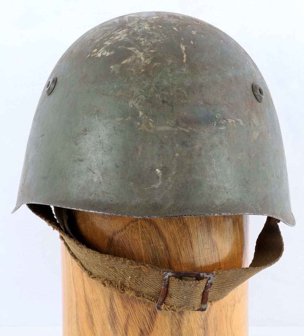 WWII ITALIAN ARMY M33 STEEL COMBAT HELMET W LINER: A WWII Italian Army M33 Steel Olive Green painted Combat helmet with full liner. Interior leather liner is intact with eight(8) fingers. Interior of the helmet is stamped, M 69. Chinstrap is also inta