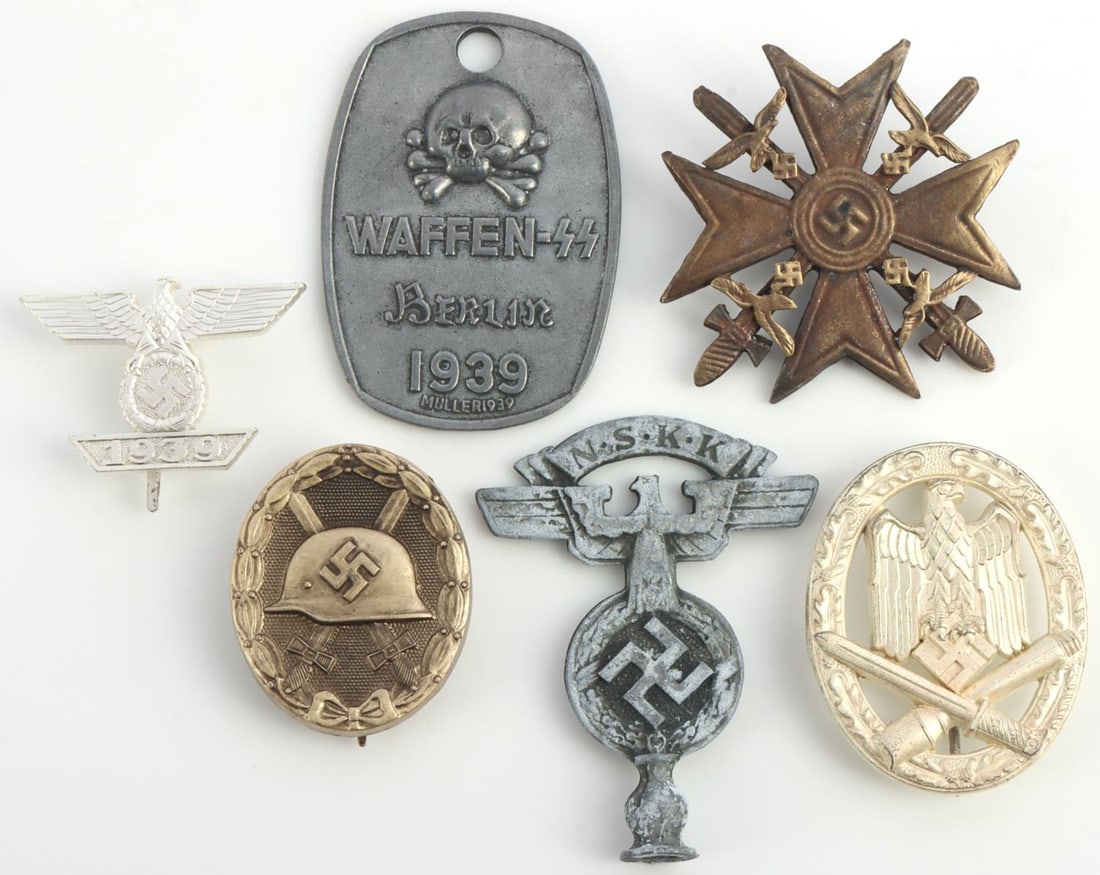 LOT OF 6 WWII GERMAN THIRD REICH SS WAFFEN BADGES: Lot of 6 WWII German Third Reich badges. Spanish Cross in bronze, Waffen SS ID tag, NSKK flag pole top, wounded badge in bronze, Army Close Support combat unit, badges and Iron Cross 1st Class 1939 cl