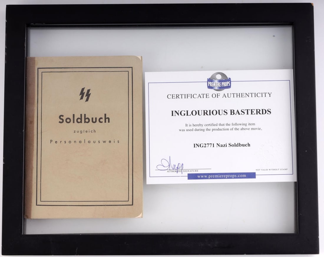 INGLORIOUS BASTERDS WAFFEN SS SOLDBUCH PROP: In very good condition, each page printed like a real Ausweis. Measures 10 15/16 X 8 7/8 inches framed.
