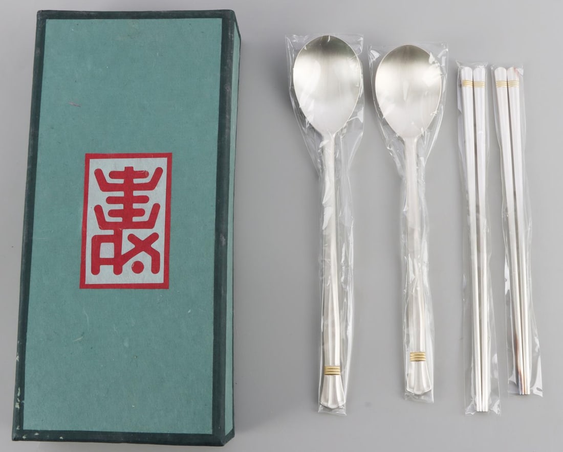 SILVER DESIGNER CHOPSTICK AND SPOON SET FOR 2: Hallmark 800 silver, signed, sealed in original wrappers with presentation box . Silver weight 235 grams This lot has a reserve.
