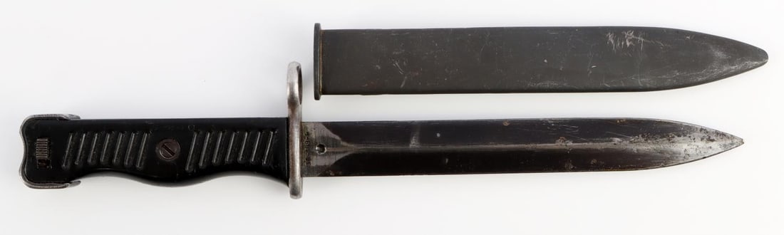 POST WWII YUGOSLAVIAN M56 BAYONET KNIFE: Yugoslavian bayonet. Steel blade numbered 64793. Black plastic grips. Housed in steel scabbard. Measures 11 1/4 inches. Very good condition.