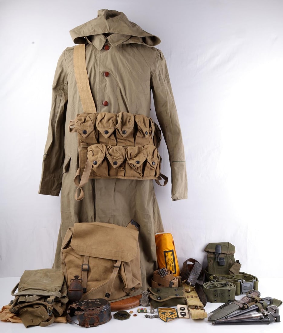LARGE LOT OF MISCELLANEOUS US MILITARY FIELD GEAR: Lot of miscellaneous United States military field gear including carrying cases, leather and canvas webb belts, wing and police badges, a MK. 21 life jacket, pack extensions, Mk. II spike bayonets, am