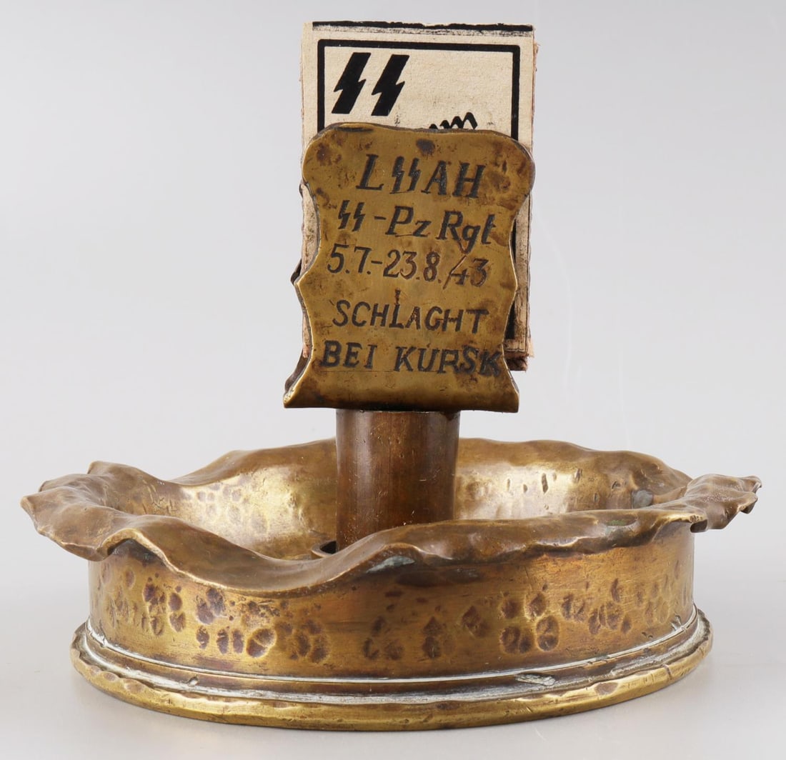 WWII GERMAN REICH SS ADOLF HITLER PANZER ASHTRAY: WWII German Reich LSSAH or "1st SS Panzer Division Leibstandarte SS Adolf Hitler " ashtray and matches. Ashtray is inscribed, "LSSAH SS-Pz. Rgt. 5.7-23.8/43 SCHLAGHT BEI KURSK." Underside has multiple