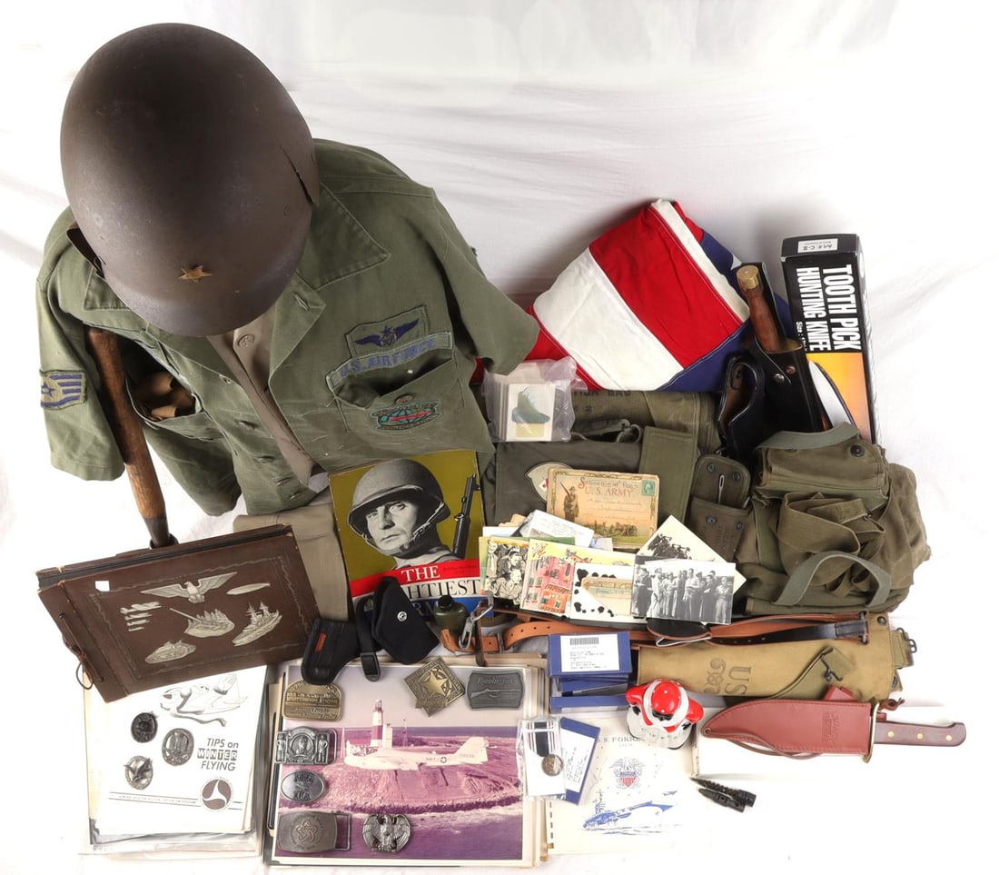 US MILITARY LOT FATIGUES MEDALS HOLSTERS AND MORE: Good variety of vintage US military gear, pilot documents flags, pins, prisoner of war medals, entrenching tool and more. As photographed.