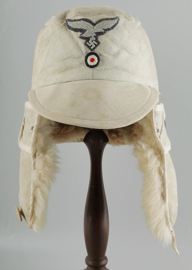 WWII GERMAN THIRD REICH LUFTWAFFE WINTER FUR CAP: Rabbit fur cap. Luftwaffe patch and cockade. Standard issue. Non-fluorescing.