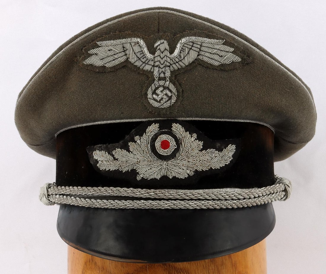 WWII GERMAN THIRD REICH ARMY OFFICER VISOR CAP: Silver bullion piping, cockade, Reichsadler, and chin cord. Size 58. Some fluorescence on patches. Very good condition with some age wear. L. Kahr name tag under maker's tag. Measures 7 3/4 inches.