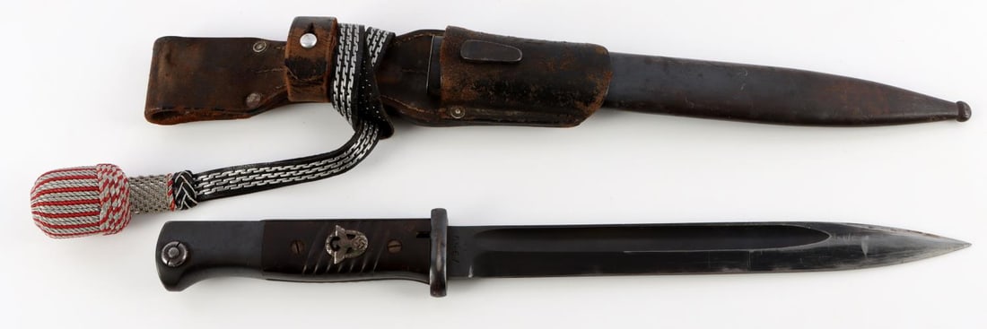 WWII GERMAN REICH SS K98 COMBAT BAYONET: A K98 combat bayonet, measuring 16 inches total length when inserted into the scabbard. It features a 9.8 inch long, patinated, magnetic steel blade with a sharpened tip and lower edge, and with fulle