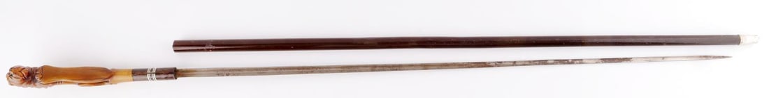ANTIQUE LION GRIP SWORD CANE WALKING STICK: Horn lion grip, above silver inlay, overall length 37 inches, push button detaches sword overall length 35 inches, metal shaft, original metal ferrule tip with "Kronprinz" inscribed, 19th very good or