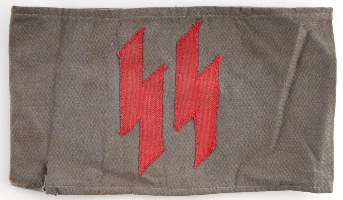 WWII GERMAN THIRD REICH RED SS RUNE ARMBAND: Cotton backing with red burlap sack runes. Measures 4 1/2 X 8 1/4 inches. Non-fluorescing. Unauthenticated, sold as is.