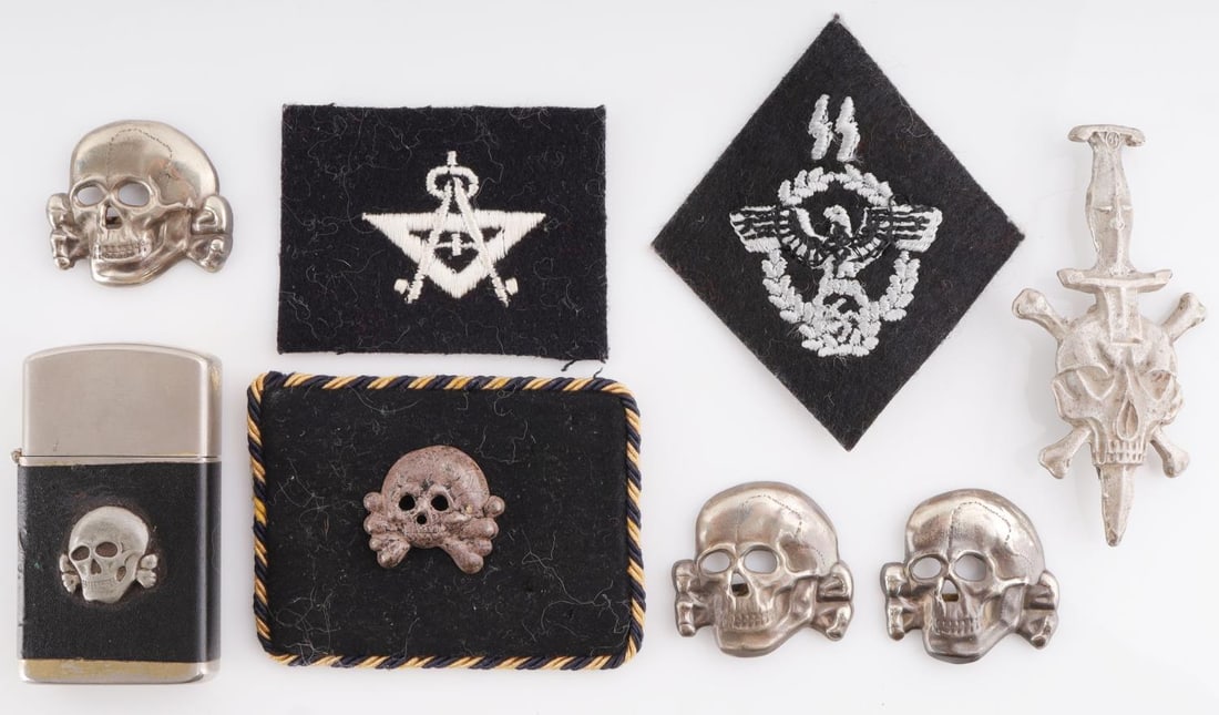WWII GERMAN SS TOTENKOPF LOT OF 8 CAP BADGES: Lot features a lighter, collar tab, 3 cap badges, 2 patches, and a pin. Measurements range 1 1/8 - 2 5/8 inches. Very good condition. Unauthenticated, sold as is.