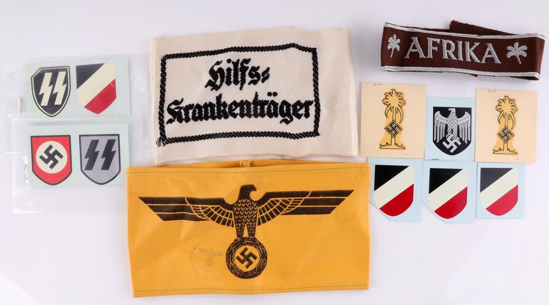 WWII GERMAN REICH HELMET DECALS & ARMBANDS: All in good condition. Includes 9 decals, and three armbands. None fluoresce. Unauthenticated, sold as is.