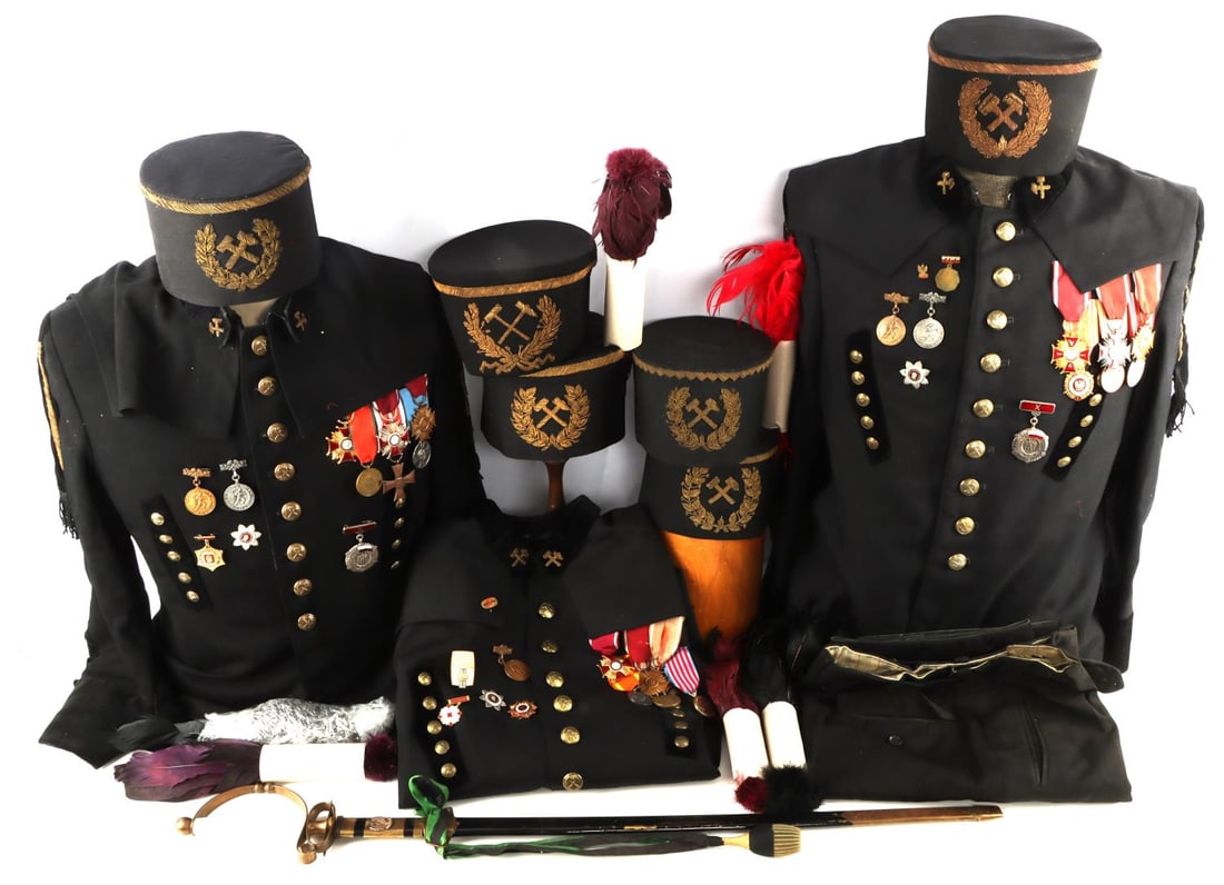 LOT OF 11 COLD WAR POLISH GALA UNIFORM & SWORD: Lot of eleven (11) items from a Cold War Era Polish Miner's parade gala uniform including six gala hats with feathers, uniform pants, three uniform tunics, and lastly a dress parade sword. Tunics/Jack