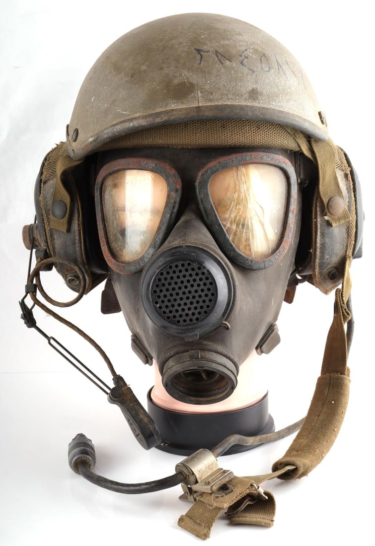 VIETNAM WAR ERA TANKER HELMET WITH LINER AND MASK: Vietnam War era Tanker’s helmet. This helmet comes with the original liner, the microphone, a cord to connect the helmet to the tank and gas mask. In good condition. Unauthenticated and sold as is.
