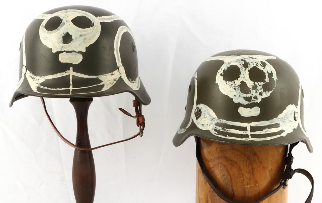 LOT OF 2 WWII GERMAN M40 HELMETS FINNISH & M40: One has prior auction tag describing one as "Original Finnish M40/55 helmet with Winter War Skull" this is a fully original M40 helmet with correct liner and chin strap, no visible internal markings, 
