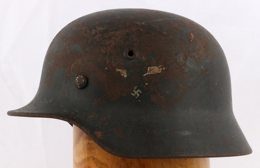 WWII GERMAN THIRD REICH LUFTWAFFE M40 HELMET: Good original mostly shell helmet, decal is mostly gone , and fairly heavy finish loss, has liner but no chin strap, named to Wm, Gruder, rear stamped 067 , left ear ET62, in spite of the detractions 