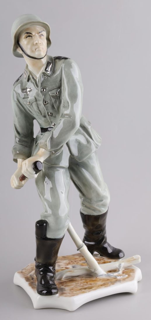 WWII GERMAN REICH PORCELAIN WEHRMACHT SOLDIER: WWII German Reich porcelain Wehrmacht soldier figurine statue. Statue depicts a German Reich soldier, "Panzergrenadier", pulling out a potato masher hand grenade. Statue features a heat stamp on the u