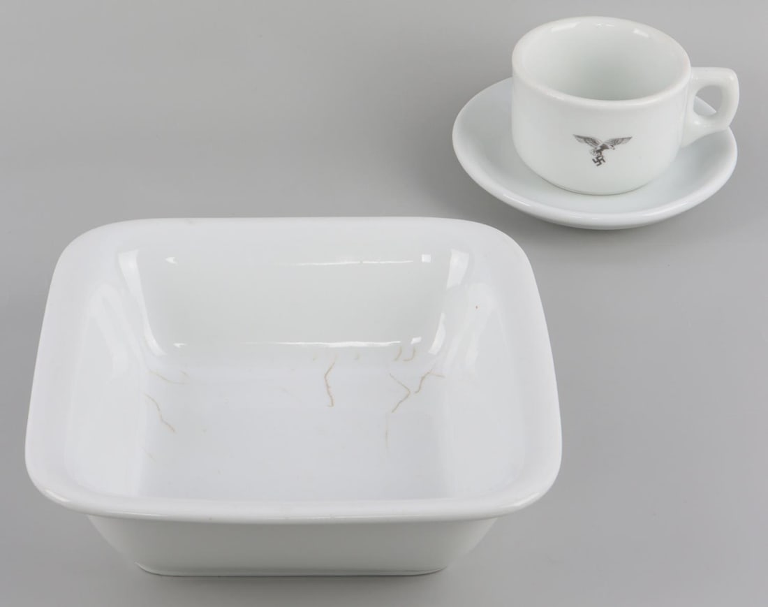 3 WWII GERMAN REICH LUFTWAFFE PORCELAIN DINNERWARE: Lot of three (3) WWII German Reich Luftwaffe Porcelain dinnerware including, a square bowl, a saucer, and lastly a coffee cup. Each item features the Luftwaffe eagle. Coffee cup's manufacturer mark, "