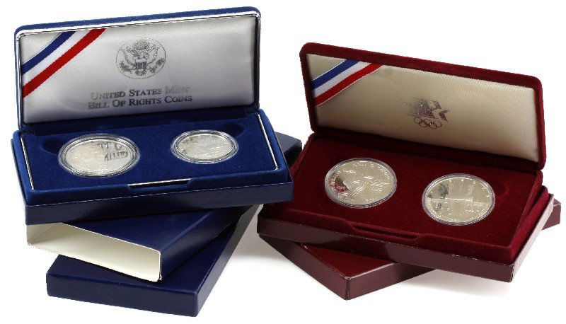 2 SILVER DOLLAR COMMEMORATIVE 2 COIN PROOF SETS: Two coins 1983 and 1984 Olympic games set and Bill of Rights 1993 dollar and half dollar sets as issued by the U.S. Mint.