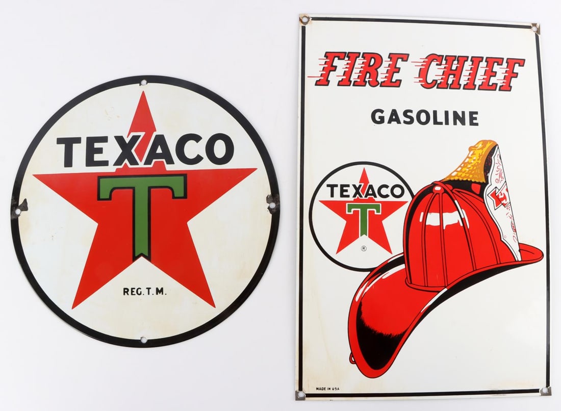 LOT OF 2 VINTAGE ENAMELED TEXACO GAS STREET SIGNS: Lot of two (2) vintage enameled Texaco gasoline street signs. Larger sign reads, "FIRE CHIEF", GASOLINE, and features the TEXACO logo and a firefighter hat. Smaller circular sign features the TEXACO l