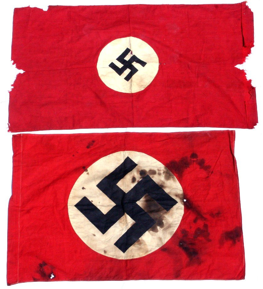 2 WWII RECOVERED THIRD REICH FLAGS: Pair of Third Reich flags recovered by US GIs during WWII. One measures 26 by 17.5 inches with a 13 inch swastika roundel, the flag has some burns and tears, the other measures 29 by 17 inches with a
