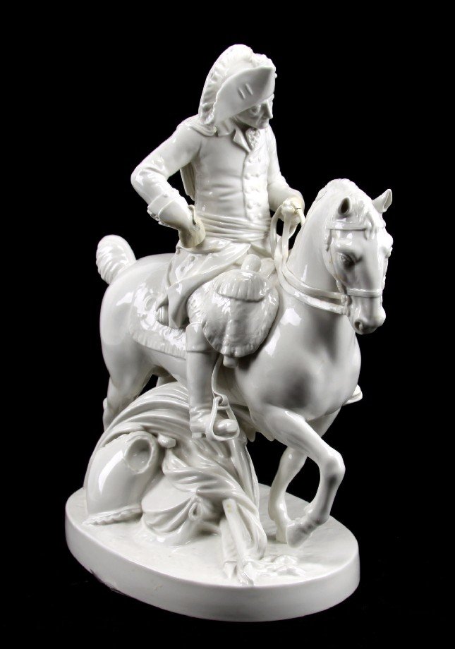 FREDERICK THE GREAT LUDWIGSBURG PORCELAIN FIGURINE: From the late 18th or early 19th-century. White paste porcelain from Ludwigsburg. Blue scepter mark under glaze. Figure of Frederick the Great on horseback standing over armor, shield, horn, sword and