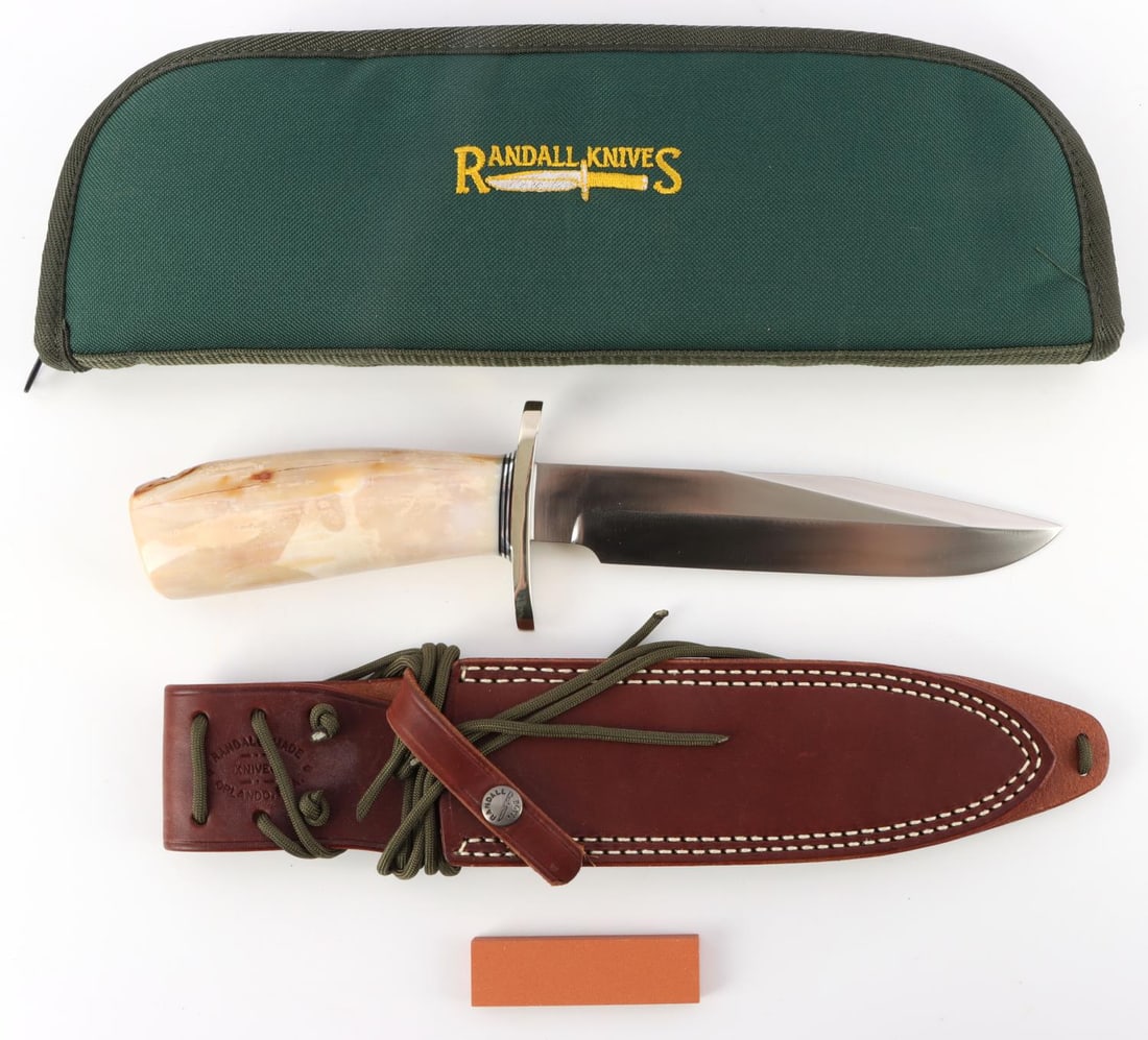 RANDALL KNIFE MODEL 14 W FOSSIL MAMMOTH HANDLE: Randall Made Model 14 Attack knife has a 7 1/2 inch blade of 1/4 inch stock. The top cutting edge is sharpened. A straight oblong hilt of 1/4 inch in brass with custom fossilized mammoth ivory handle.