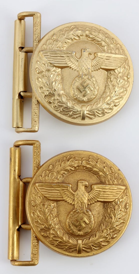 2 WWII GERMAN NSDAP POLITICAL LEADER BELT BUCKLES: Lot of two (2) WWII German Reich NSDAP Political Leader's belt buckles. Aluminum construction. Original gilded finish is very bright with color and shine. Reverse sides are marked, "RZM, M4/24" and "R