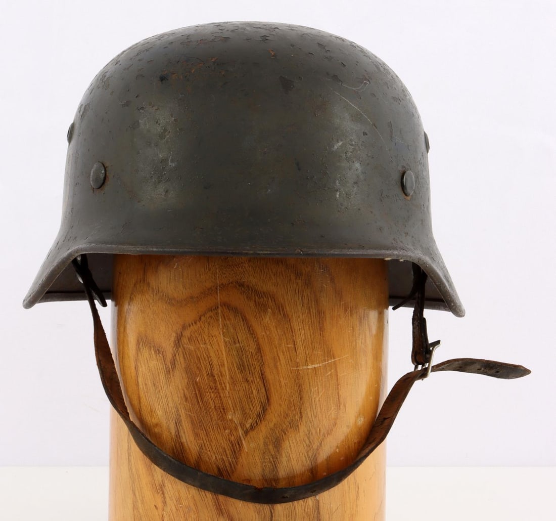 WWII GERMAN SS M38 STAHLHEIM HELMET: Very good original condition, original liner and chinstrap, rear impressed 2160, above left ear 880.