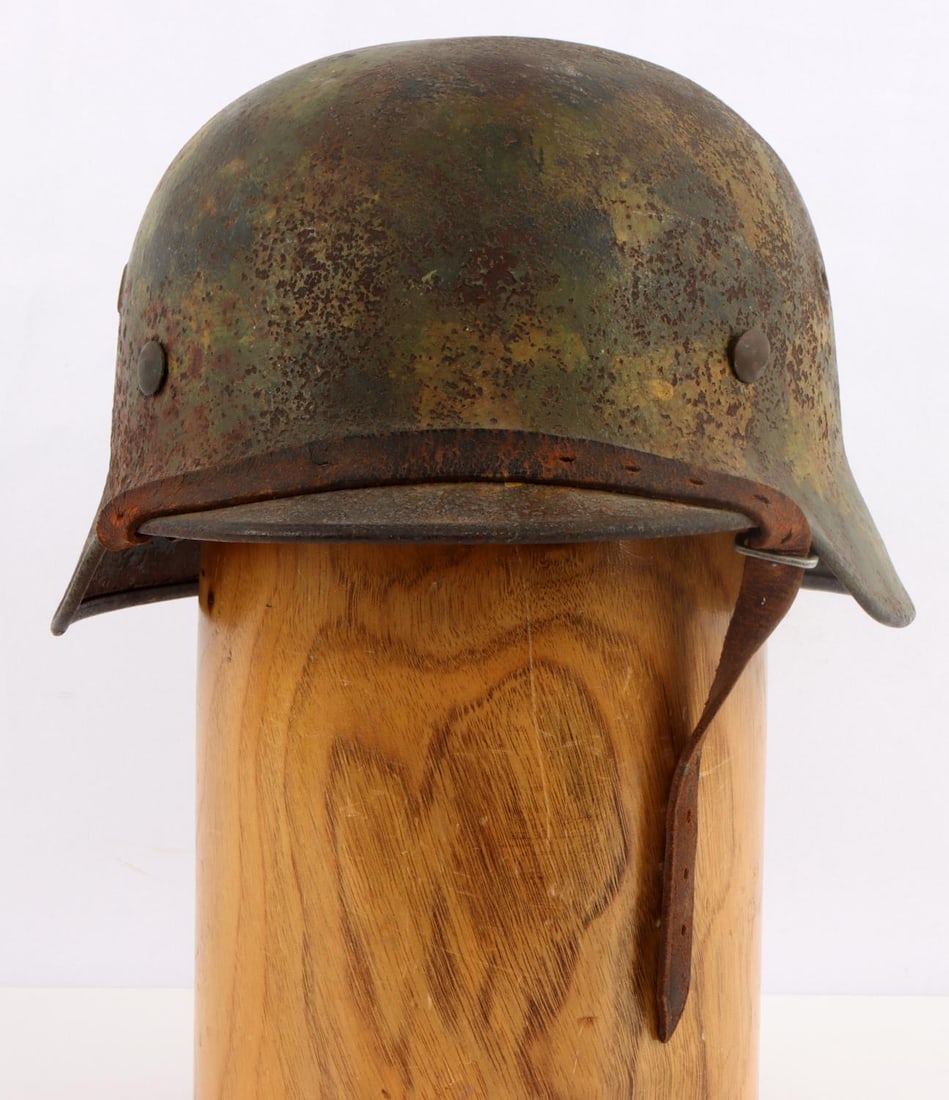 BATTLEFIELD RECOVERED WWII M40 GERMAN SS HELMET: Stampings rear and over left ear but not discernable, original as found condition, painted SS runes as well as national colors, liner , suspension and chinstrap. Old tag left in place.