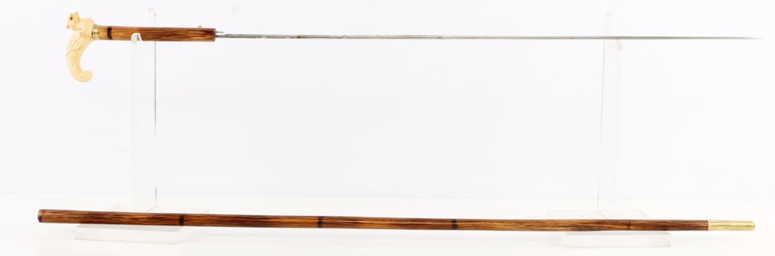 ANTIQUE PHEASANT GRIP SWORD CANE WALKING STICK: Schreger line in tusk grip, 19th century sword cane, very good original condition, bamboo shaft, brass ferrule tip, blade and grip measures 27 inches, overall 33 inches.