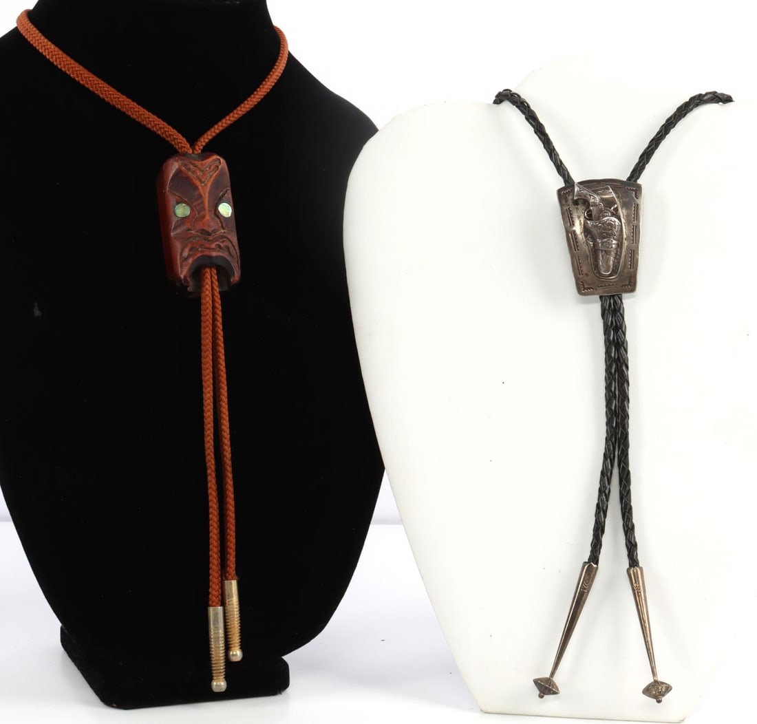 2 BOLO TIES SILVER SINGLE ACTION MAORI NEW ZEALAND: Silver single action revolver, reverse signed with fish image, and Maori, Moko, N.Z. wood.