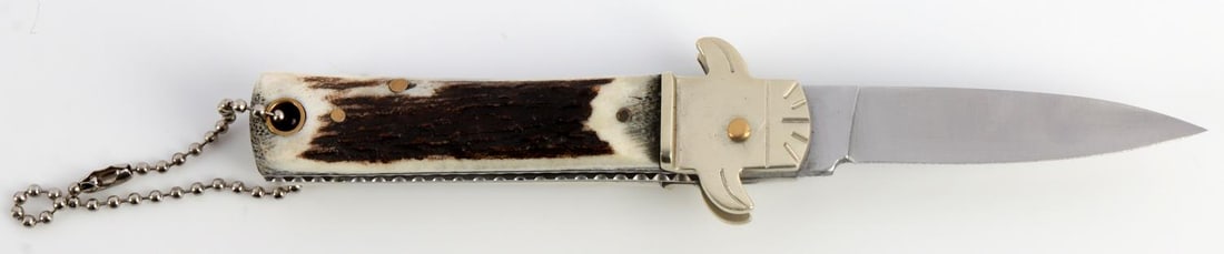 GERMAN HEBECTUS SOLINGEN POCKET KNIFE: Automatic knife. Steel blade. Stag grip. It measures 6 1/8 inches.