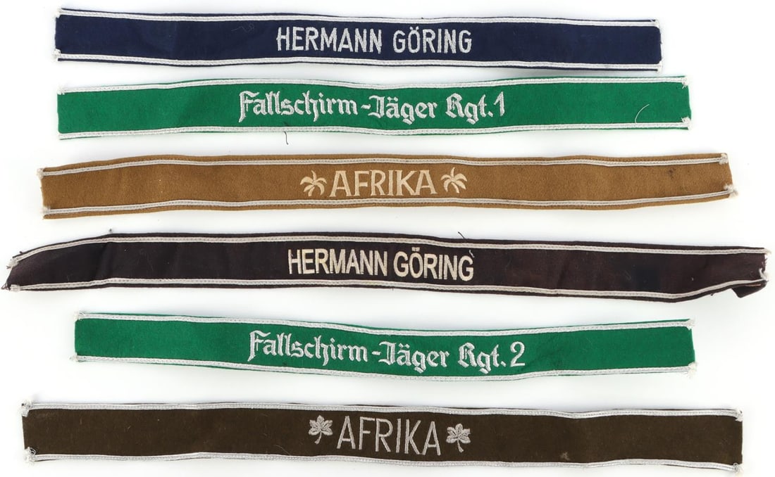 LOT OF 6 WWII GERMAN CUFF TITLES LUFTWAFFE: Featured are Hermann Goring, Paratrooper, and Afrika Corps. All fluoresce except Afrika cuff titles. Measures 18 inches.