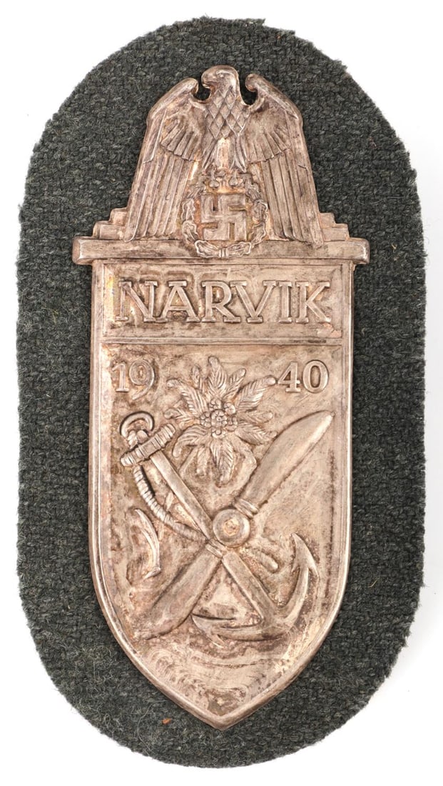 WWII GERMAN THIRD REICH NARVIK SLEEVE SHIELD: Silvered brass sleeve shield on felt back. Measures 4 inches. Very good condition with patination.