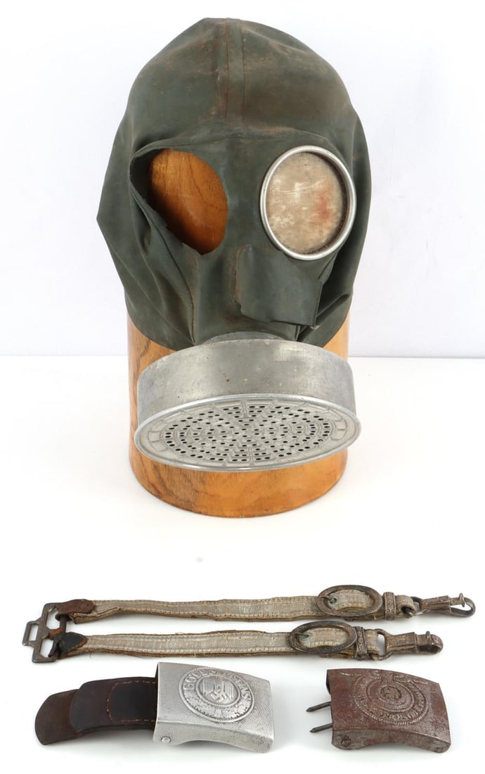 WWII GERMAN THIRD REICH GAS MACK & BELT BUCKLE LOT: Lot includes 1 WWII German civil defense VM37 (Volksgasmaske 37) gas mask and filter. 1 lens is missing1 WWII German dagger belt strap. 1 WWII German steel belt buckle. Stamped RZ 3642 on the reverse.
