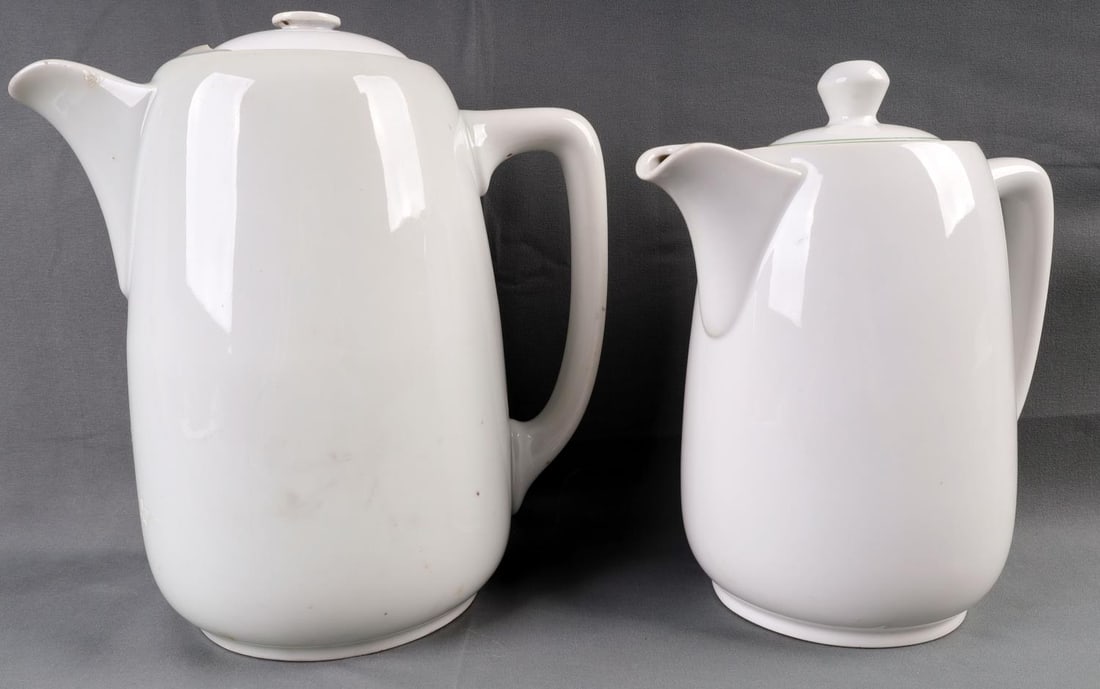 WWII GERMAN REICH HEER ARMY PORCELAIN PITCHER LOT: Lot of two (2) WWII German Reich Heer Army Porcelain mess hall pitchers. Both include their lid. Both pitcher's underside features the Heer eagle stamp and manufacturer marks including "C.T. TIELSCH-A