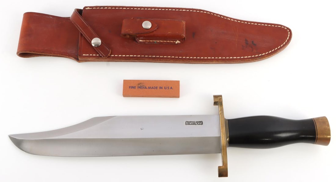 RANDALL MADE MODEL 12 SMITHSONIAN BOWIE KNIFE: 11-inch blade of 3/8 inch carbon steel stock. The top cutting edge is sharpened approximately 4 3/4 inch. Brass lugged hilt, custom black Micarta handle with brass butt cap. This lot has a reserve.