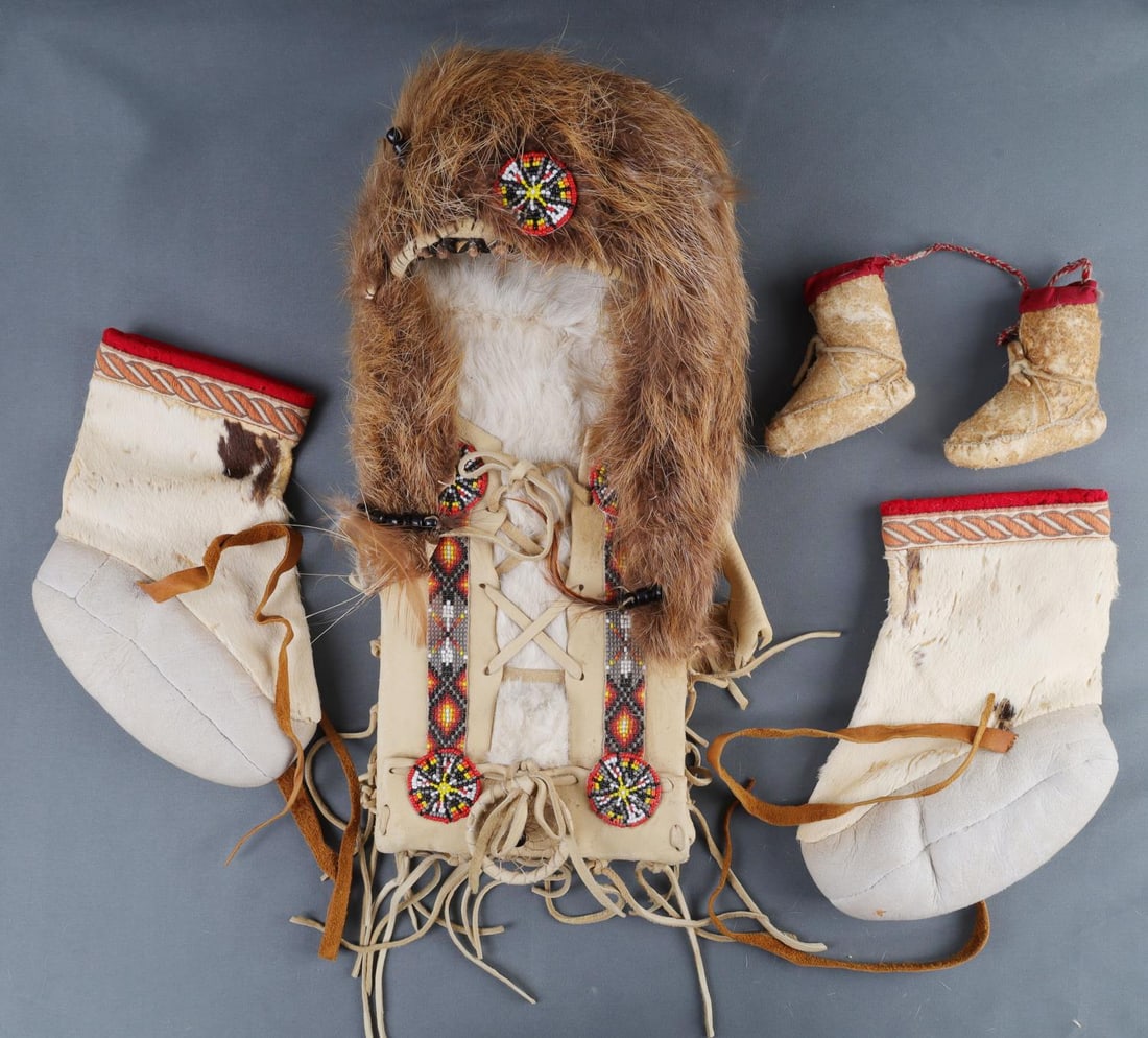 PLAINS NATIVE AMERICAN BEADED & LEATHER LOT: Plains Native American beaded leather baby carrier. This comes with a set of baby moccasins. With a dream catcher and shoulder straps. Pain of of child's moccasins there is some fur loss on the leathe