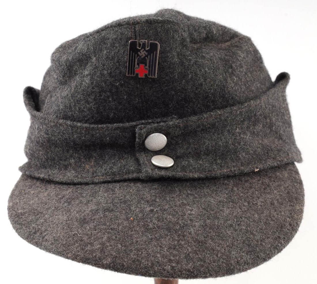 WWII GERMAN REICH RED CROSS M43 WOOL FIELD CAP: WWII German Reich M43 Wool Field Cap that features a German red cross eagle badge and two pebbled buttons. Interior of the cap features a manufacturers tag marked, "BOSBACH & CO GAGGENAU/MUROTAL" and 
