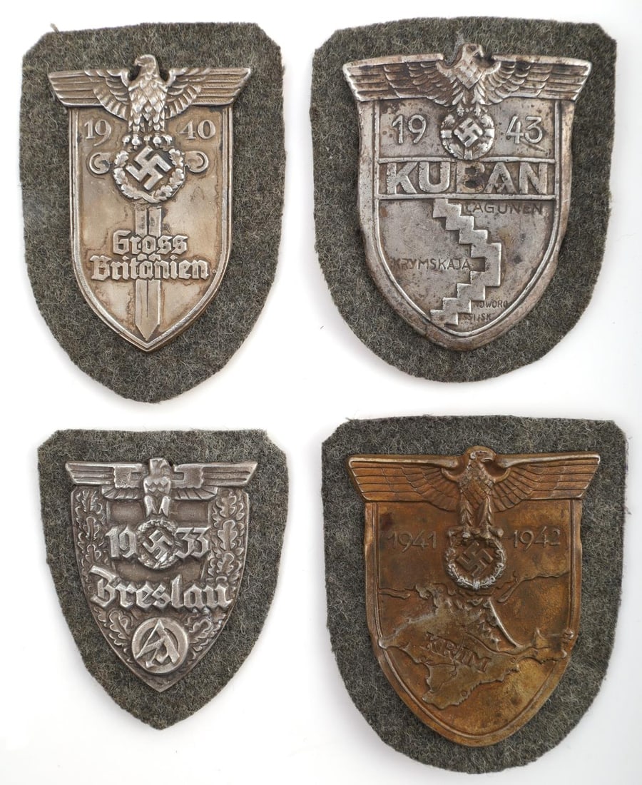 WWII GERMAN THIRD REICH SLEEVE SHIELD LOT OF 4: WWII German Army Kuban sleeve shield featuring a German eagle with outstretched wings clutching a laurel wreath containing a swastika. WW2 German Krim Shield 1941 - 1942. WWII German Third Reich Gross