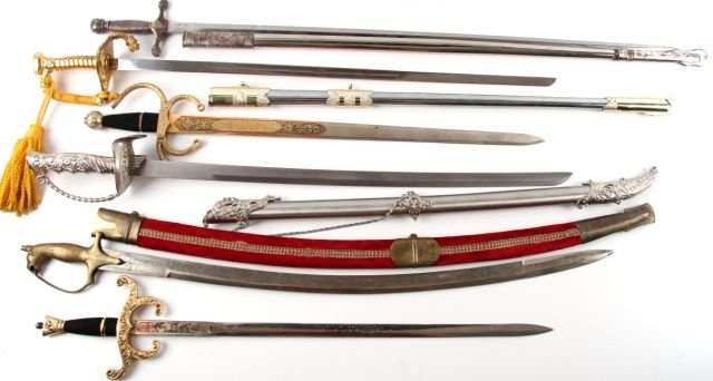 6 REPRODUCTION SWORDS CAVALRY SPANISH INDIAN: Swords measure between 39 and 29 inches. Swords include: two Spanish Conquistador, one Indian with velvet scabbard, a US Cavalry, and two decorative fantasy swords. Condition varies from good to very 