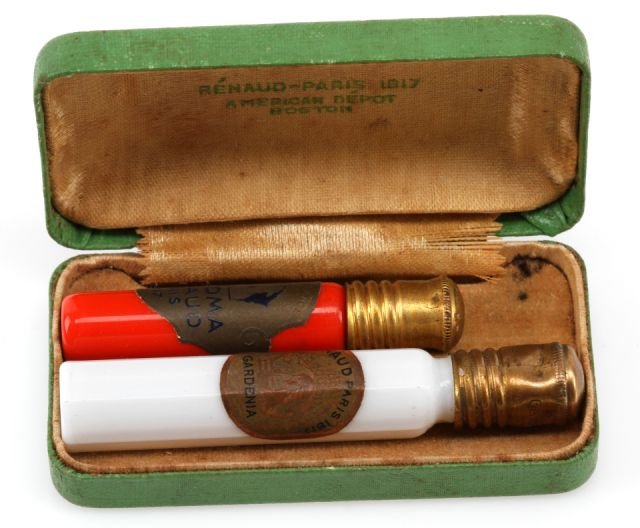 RENAUD OF PARIS PERFUME BOTTLES WITH BOX: One set of perfume bottles, Renaud of Paris 1917, original satin lined box, containing one opaque white bottle, 2.5" tall, brass screw-on cap, Gardenia scent, and one poppy red color, 2" tall, brass s
