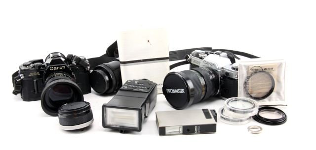 CANNON AE-1 35MM CAMERAS LENSES FLASHES & FILTERS: Two Cannon AE-1 camera bodies, Albinar ADG 80-200mm 1:3.9 lens, Promaster MC 28~70mm 1:2.8~4.2, teleconverter, Cannon 50mm 1:1.4, Sunpak Autozoom 333, Cannon Speedlight 011A, Vivitar 52mm VMC-Filter, 
