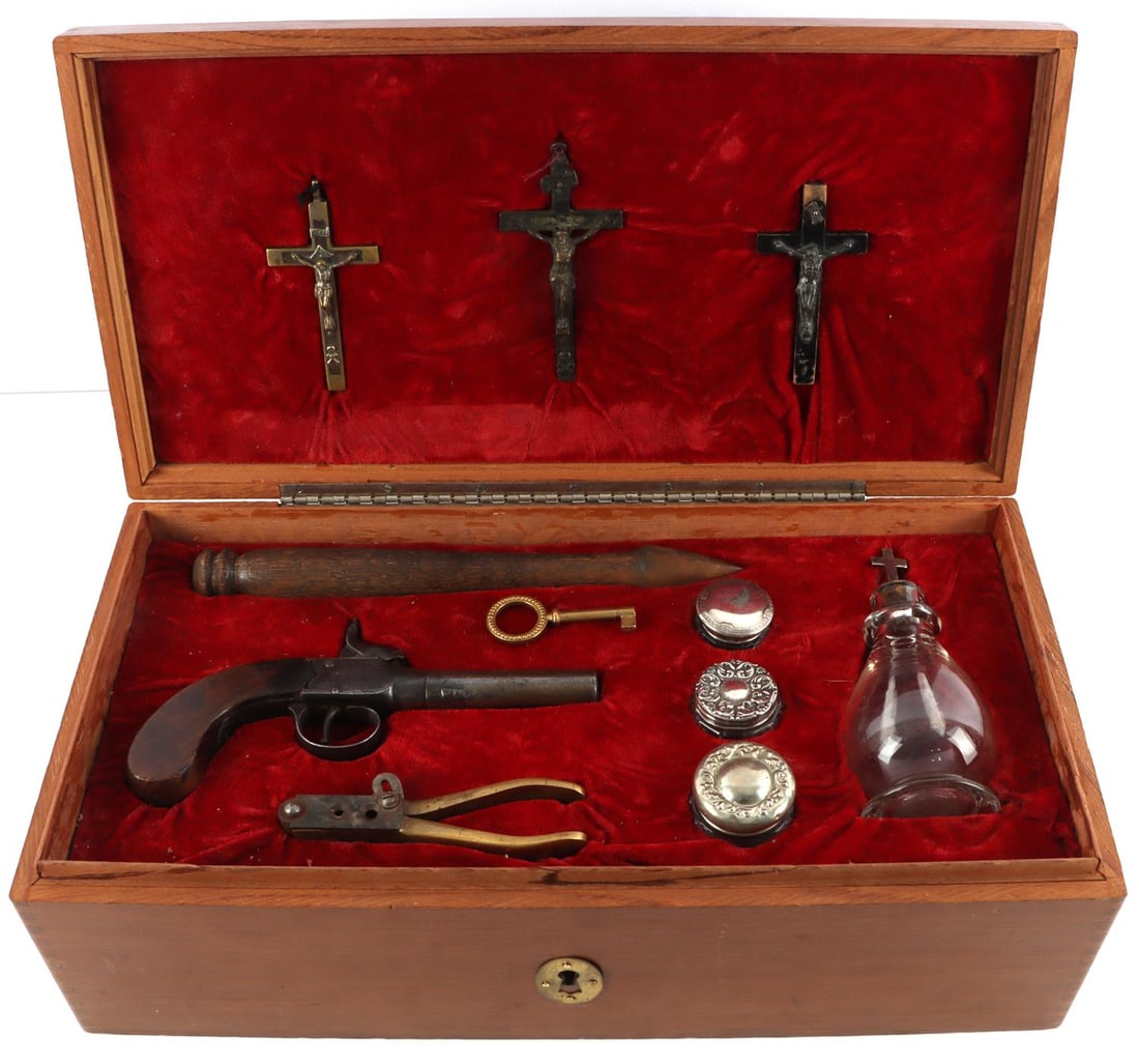 19TH CENTURY ANTIQUE VAMPIRE HUNTER KILLING KIT: Spanish cedar box with false keyhole. Measures 16 7/8 X 8 1/2 X 5 1/4 inches. Three Christian crucifixes in various form with metal Christ and INRI inscription. 19th century English pistol with smooth