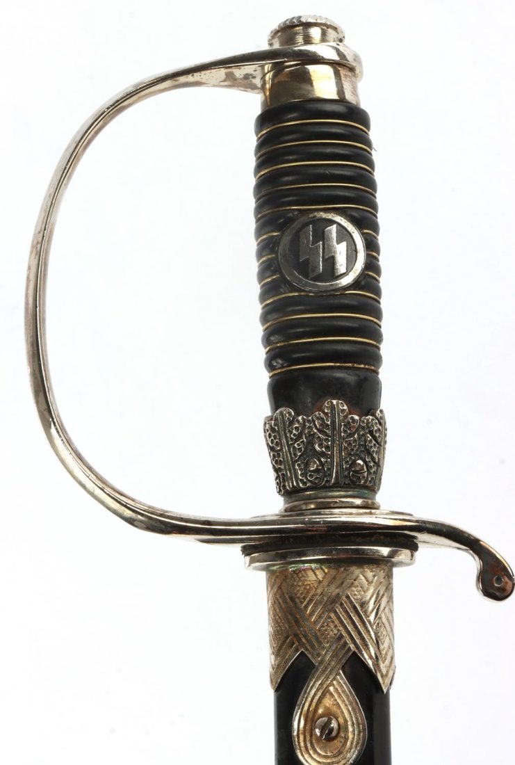WWII GERMAN THIRD REICH SS DEGEN SWORD: Nickel-plated steel blade. Rune marked scabbard and hilt. 13 band synthetic grip. Measures 39.75 inches. Post-war wall hanger.