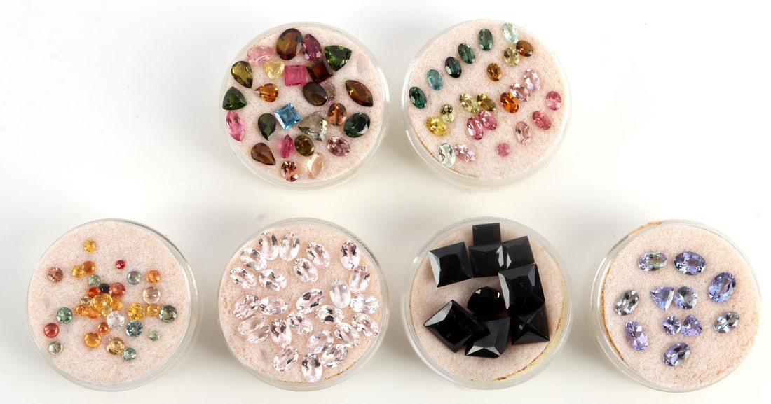 65 CTW MIXED GEMSTONE DEALERS LOT: Approximately 65 carats multicolored gemstones, including Tanzanite, Pink Beryl, tourmaline, black spinel, and sapphire. In labeled containers. This lot has a reserve.