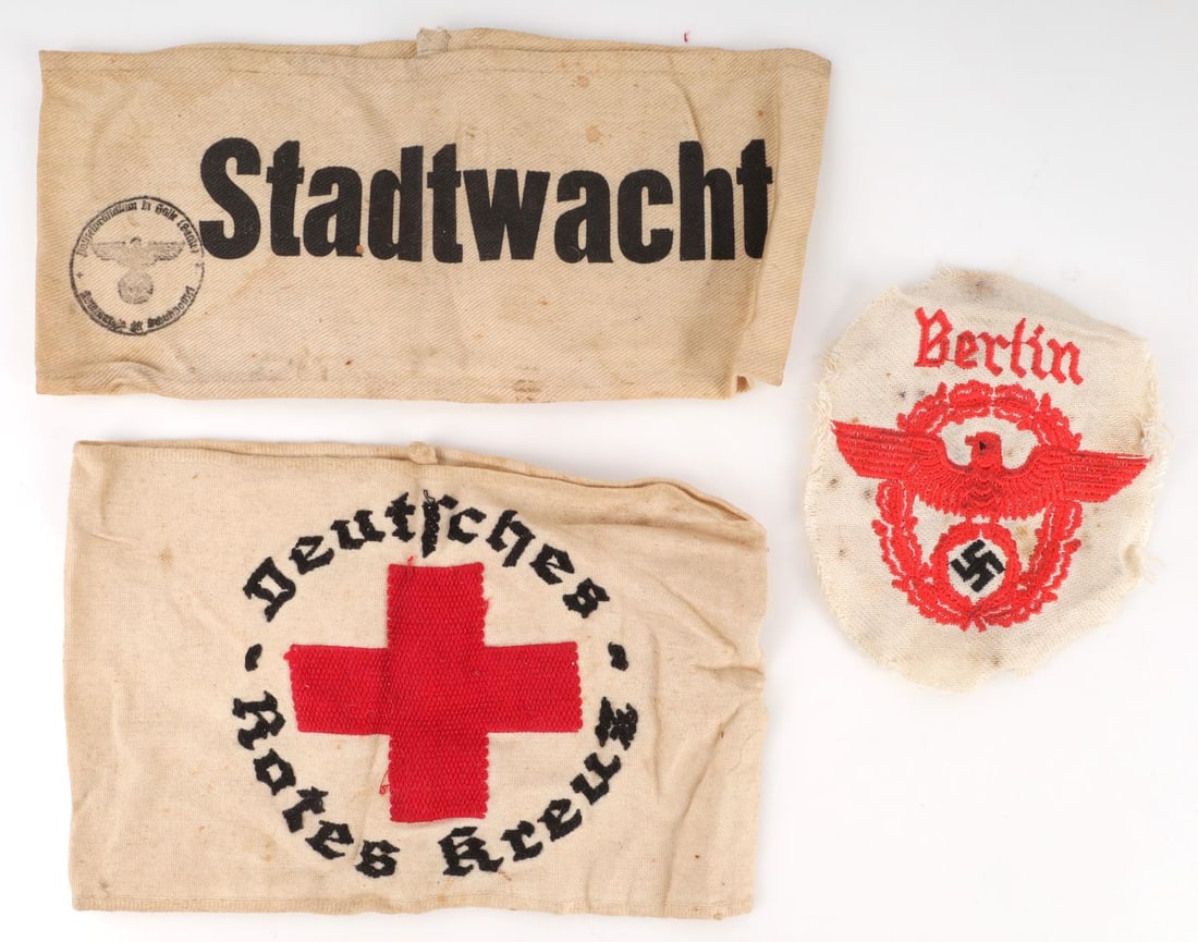 WII GERMAN THIRD REICH ARMBAND & SLEEVE EAGLE LOT: WWII German Red Cross armband. WWII German City Watch armband. WWII German traffic Police NCO/EM sleeve eagle. All three do not fluoresce under black light and in very good condition. Unauthenticated,