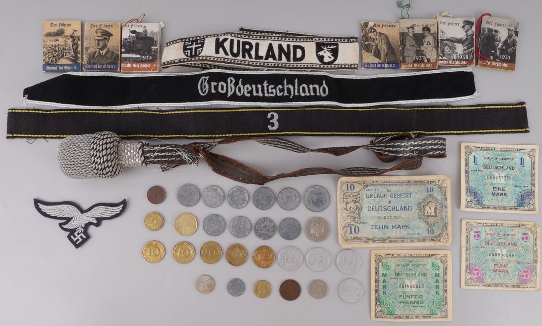 12 WWII GERMAN CUFF TITLES & DER FURHER MINI BOOKS: Lot of twelve plus (12+) WWII German Reich items including paper and coin money, cuff titles, and miniature books. Lot features a silver bullion epaulette, a cuff title marked "3" (RZM tag), a Gro?deu