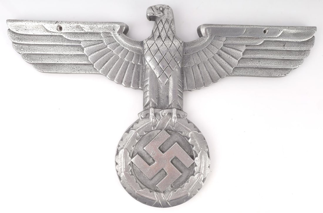 WWII GERMAN THIRD REICH EAGLE RAILWAY PLATE: WWII German NSDAP solid aluminum railroad plate. Plate depicts a Nazi eagle with straight wings over a swastika, engraved with detailed patterns. Dimension: 15 X 10 inches. Unauthenticated, sold as is